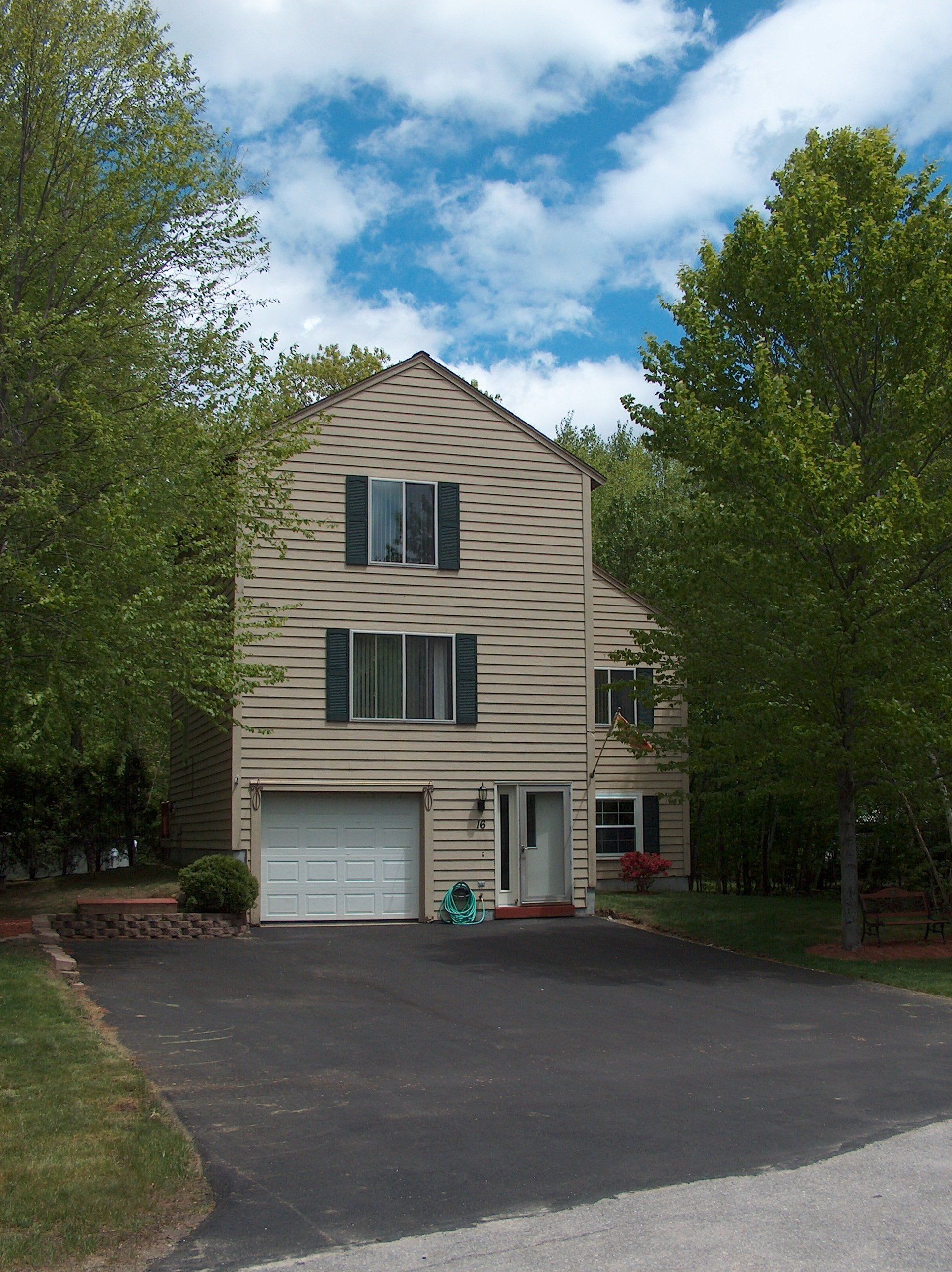 A house with a white garage door and black shutters