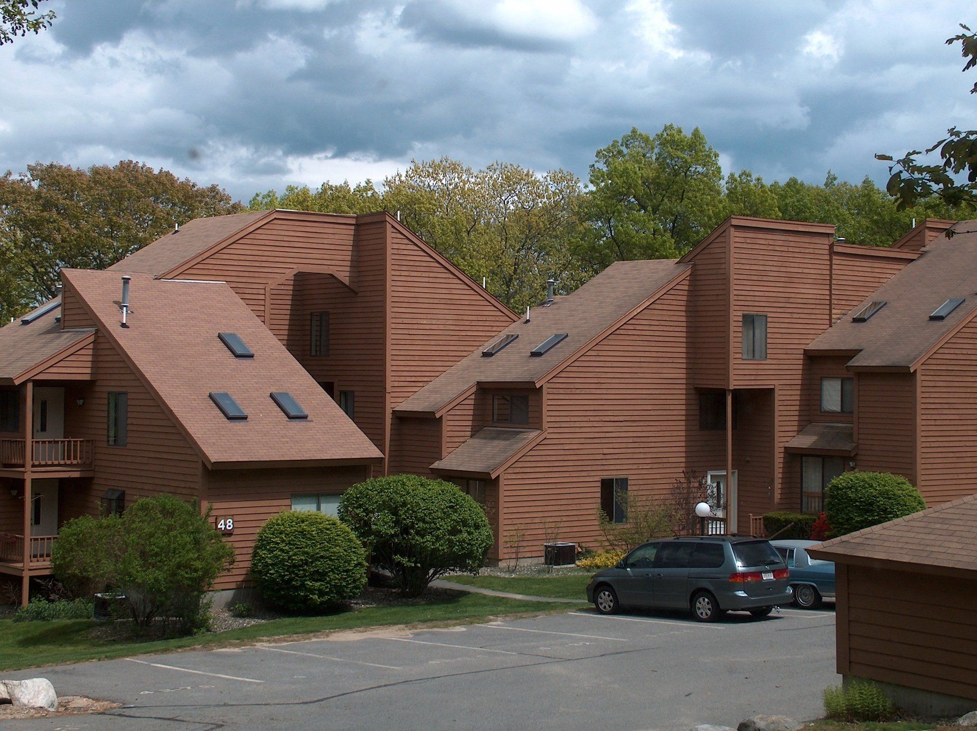 A van is parked in front of a row of houses