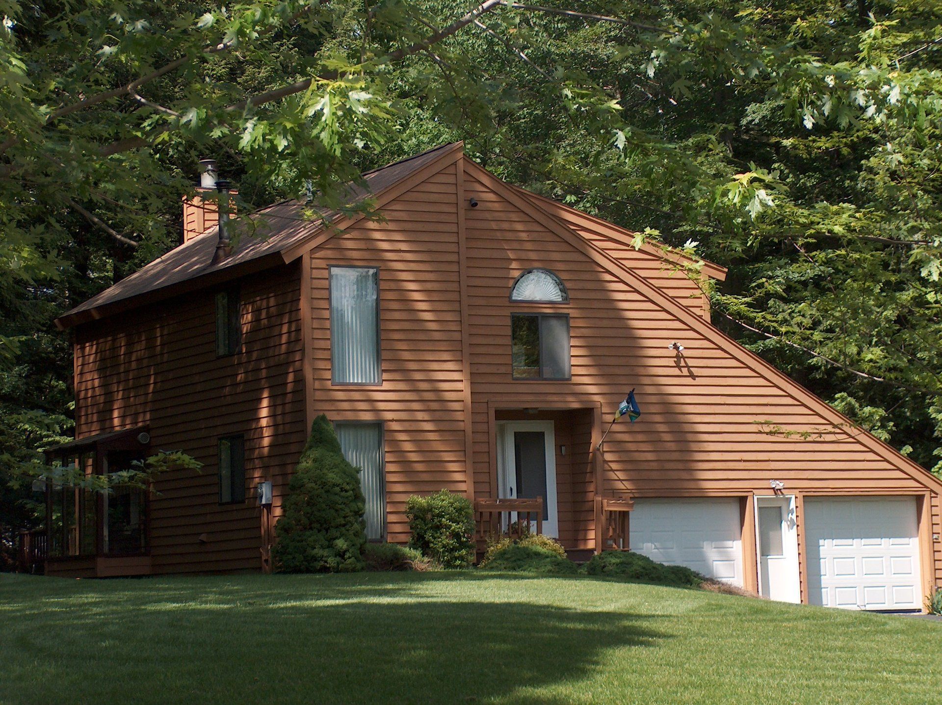 A large brown house with a triangle shaped roof