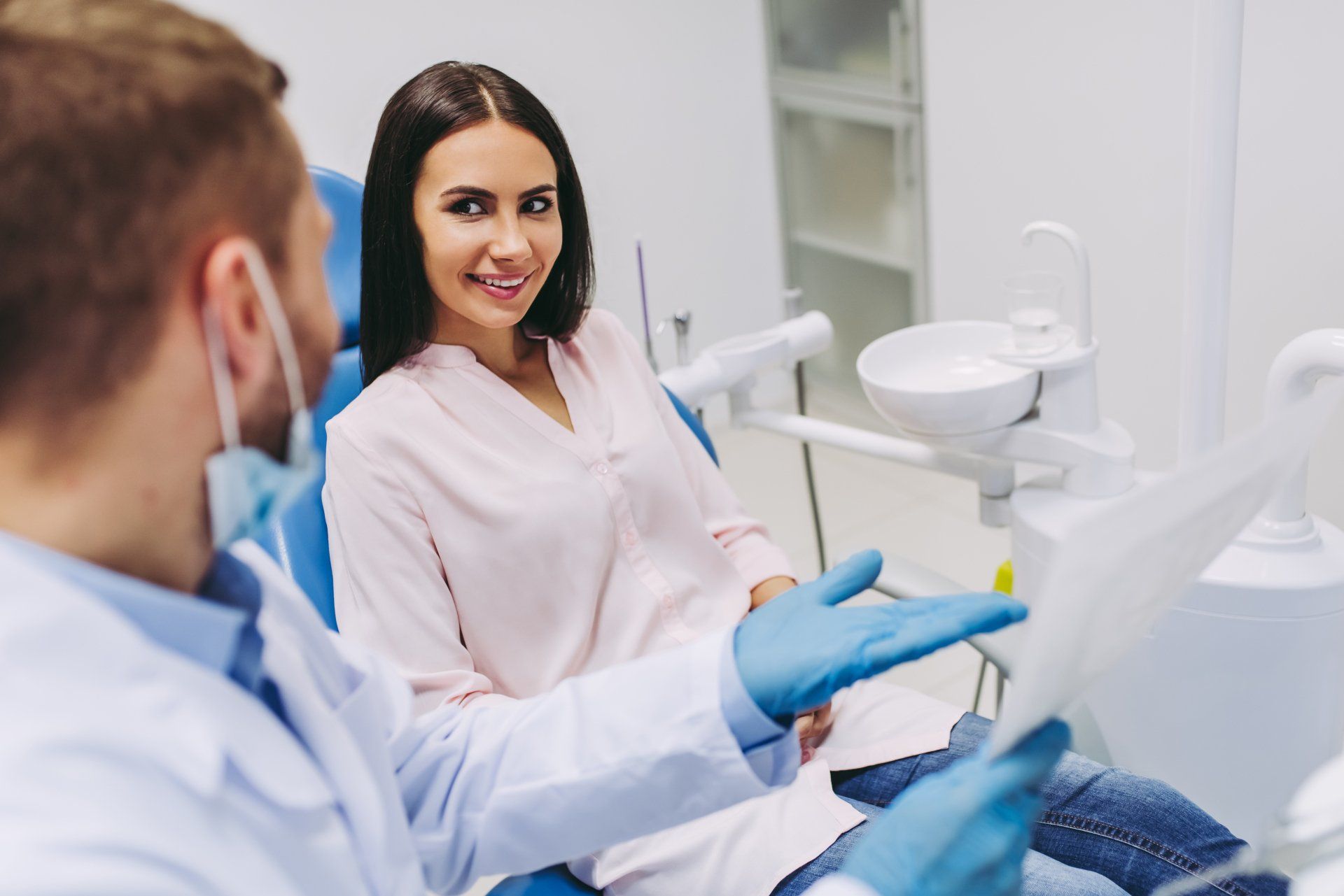 Dentist Looking At X-ray In Modern Clinic - Dental Treatments in Port Macquarie, NSW Dentist Looking At X-ray In Modern Clinic - Dental Treatments in Port Macquarie, NSW