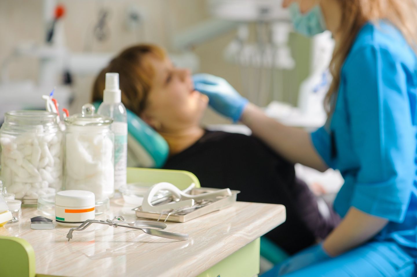 Dentistry Tools On Foreground And Female Dentist Doing First Check-up - Dental Treatments in Port Macquarie, NSW Dentistry Tools On Foreground And Female Dentist Doing First Check-up - Dental Treatments in Port Macquarie, NSW
