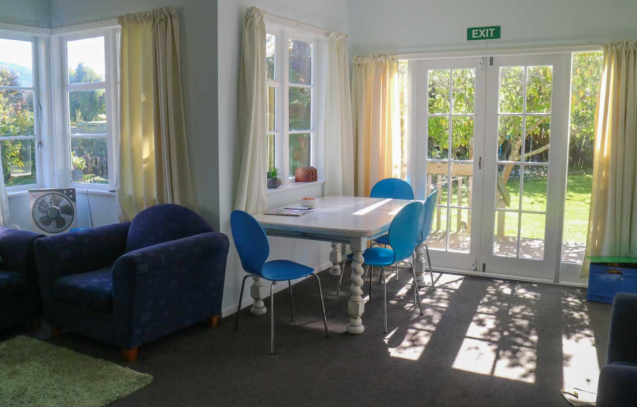 chairs and table next to windowed door