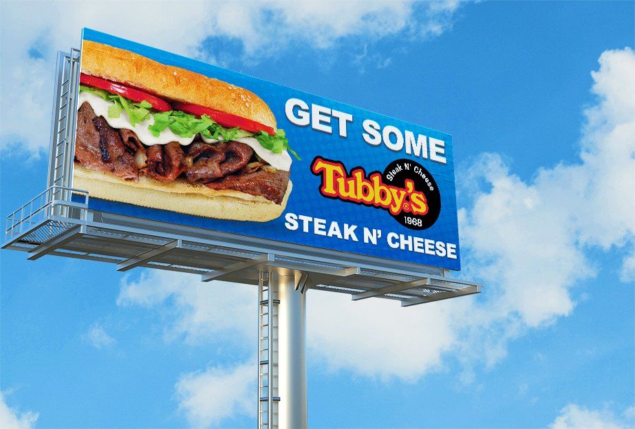 A billboard that says get some tubby 's steak n cheese