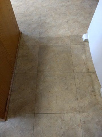 A close up of a tiled floor in a kitchen.
