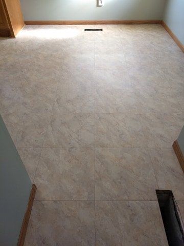 A room with a tiled floor and a window.