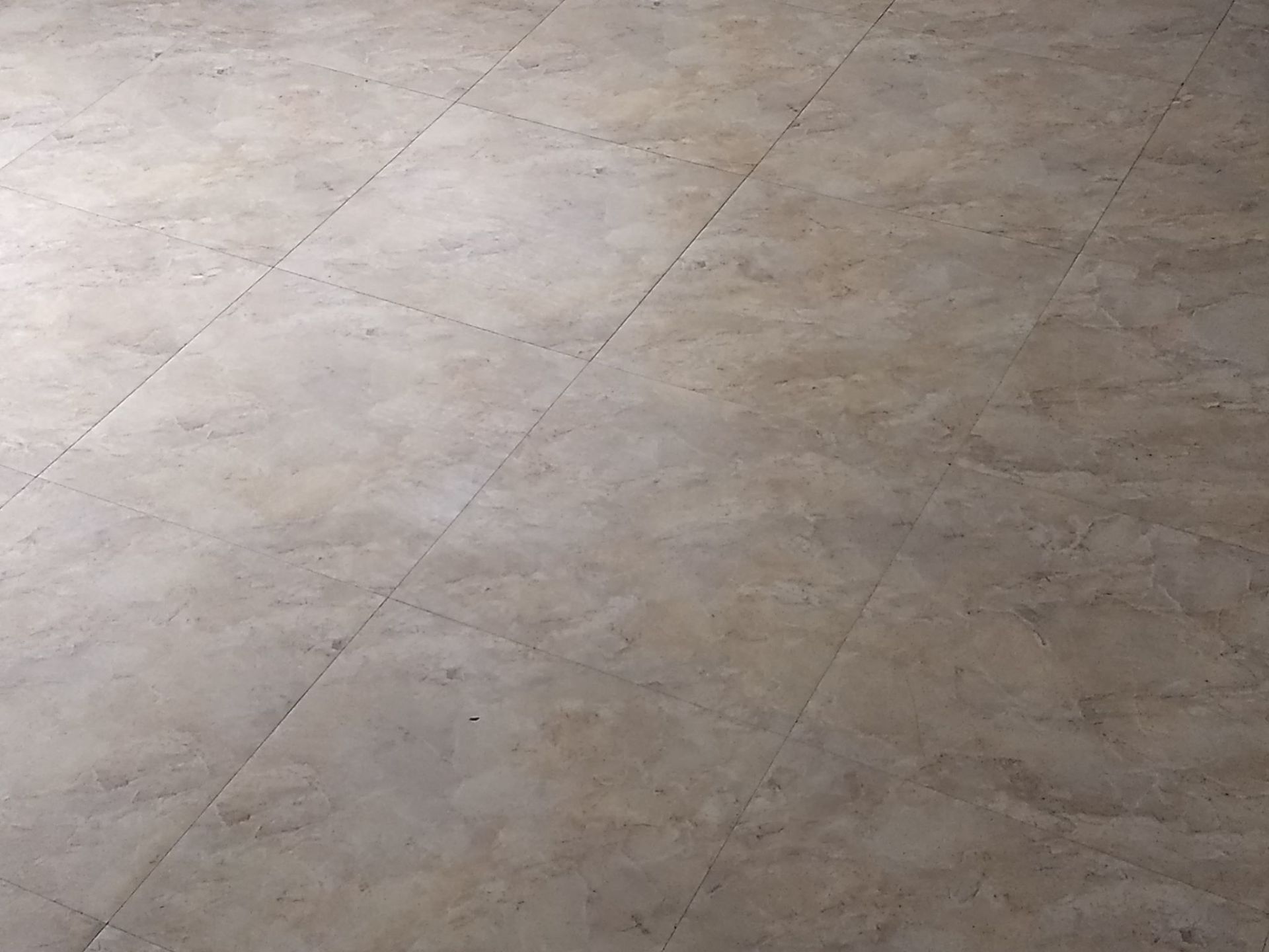 A close up of a tiled floor in a room.