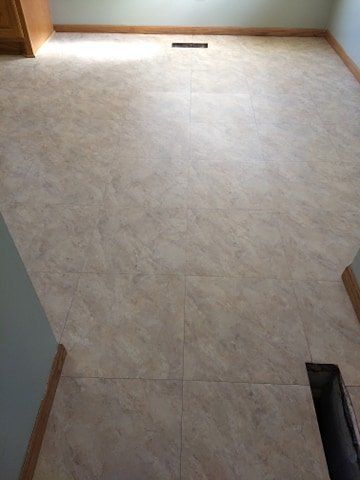 A room with a tiled floor and a fireplace.