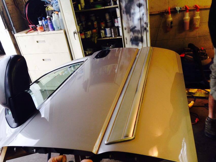 a car door is sitting in a garage next to spray bottles