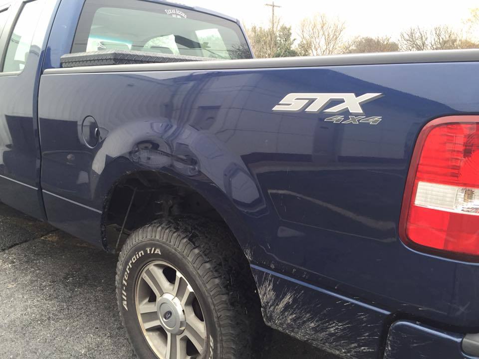 a blue stx 4x4 truck with a bfgoodrich tire