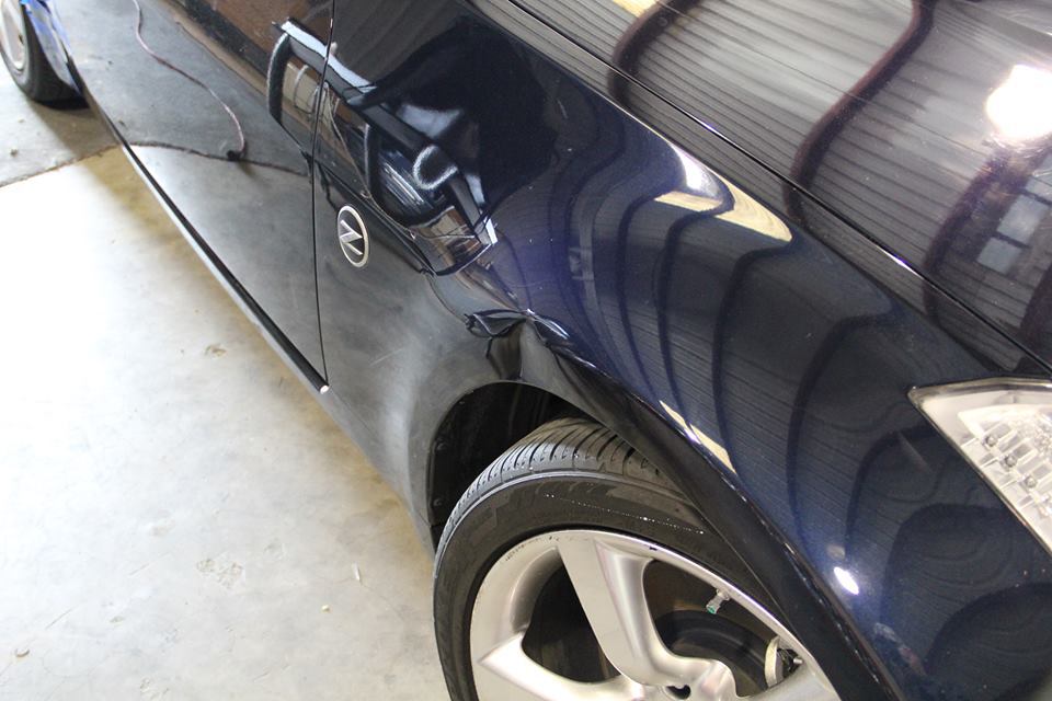 a blue car with a nissan logo on the door