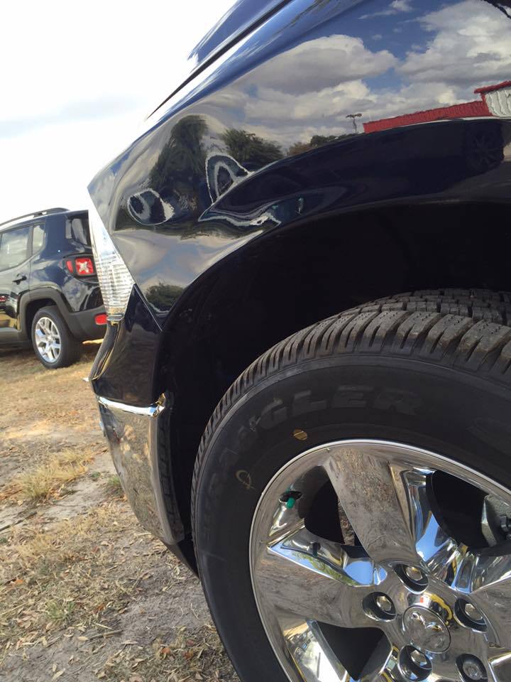 a jeep is parked next to a ram truck
