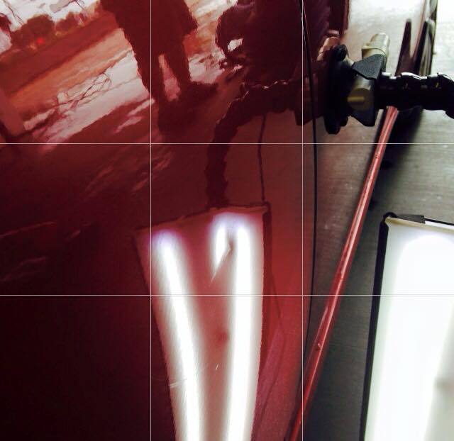 a close up of a red car with a light on it .