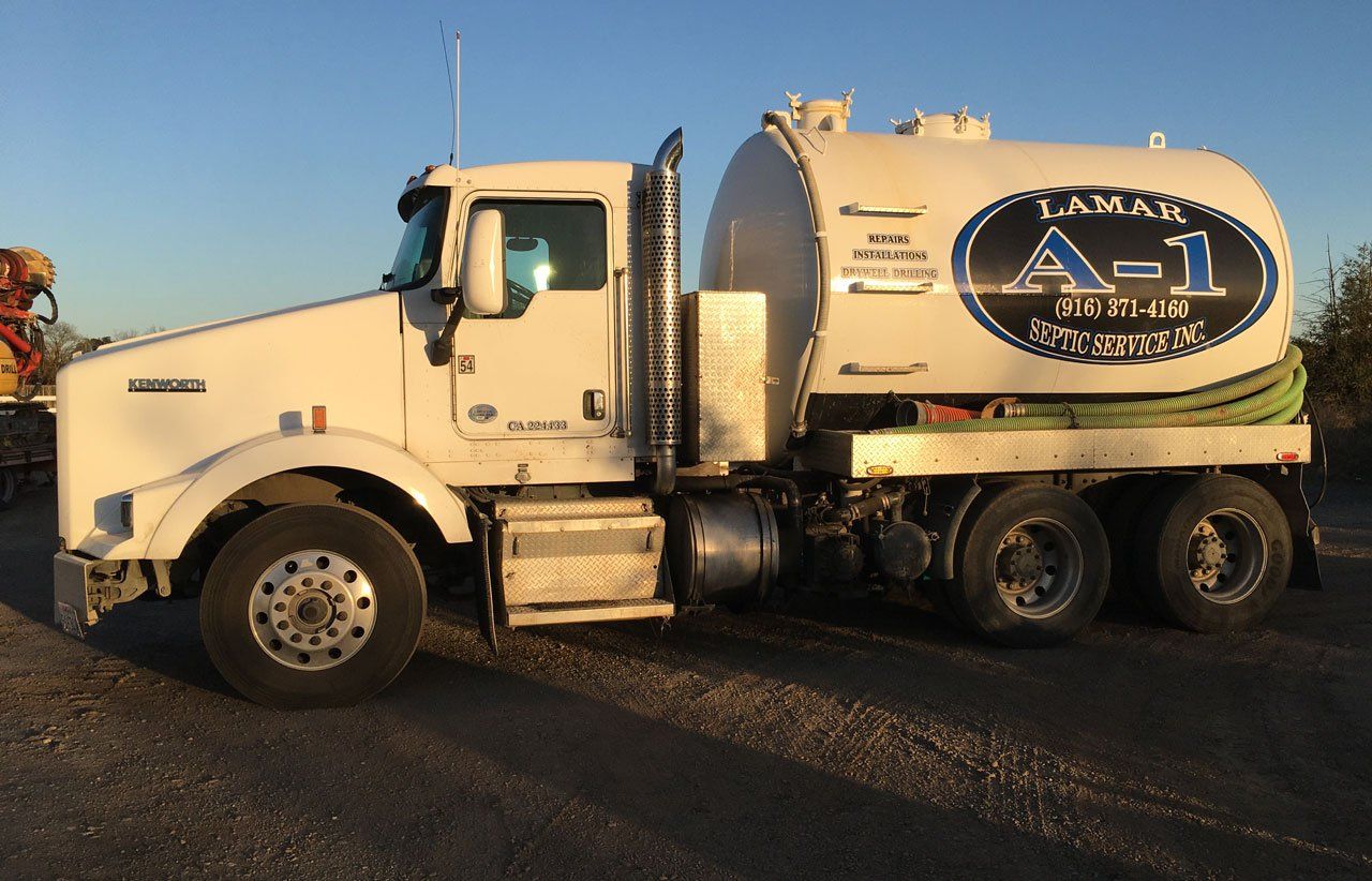 Backhoe with Dozer — Sacramento, CA — Lamar A1 – Septic Services Inc. A truck used for septic pumping in Wilton, CA