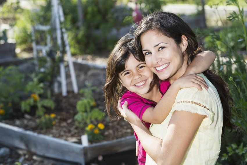 smiling mother hugs daughter