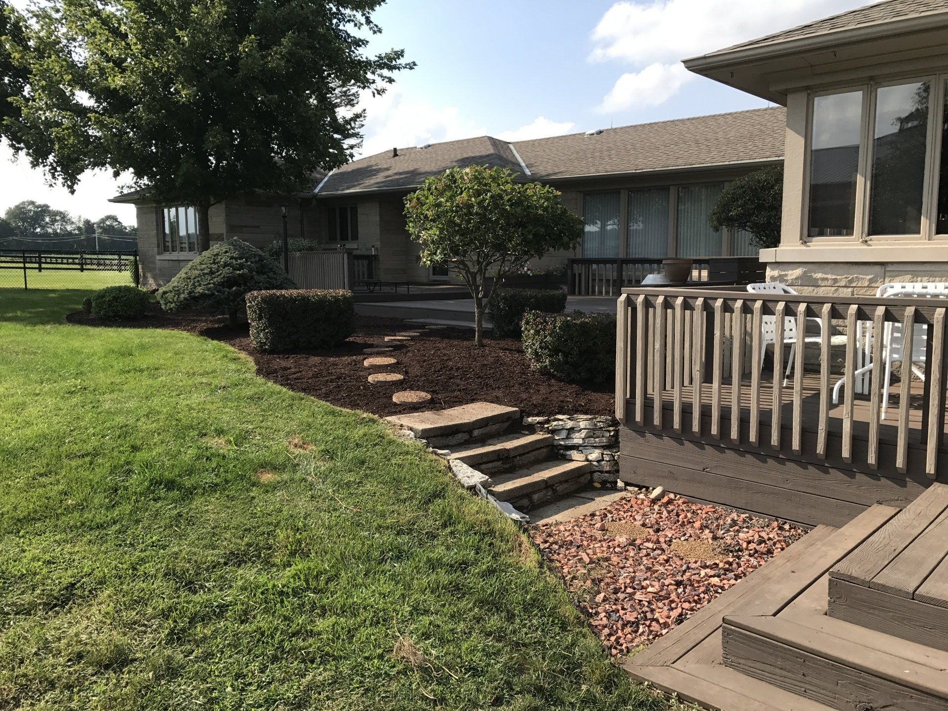 back yard with freshly laid pavers and new deck