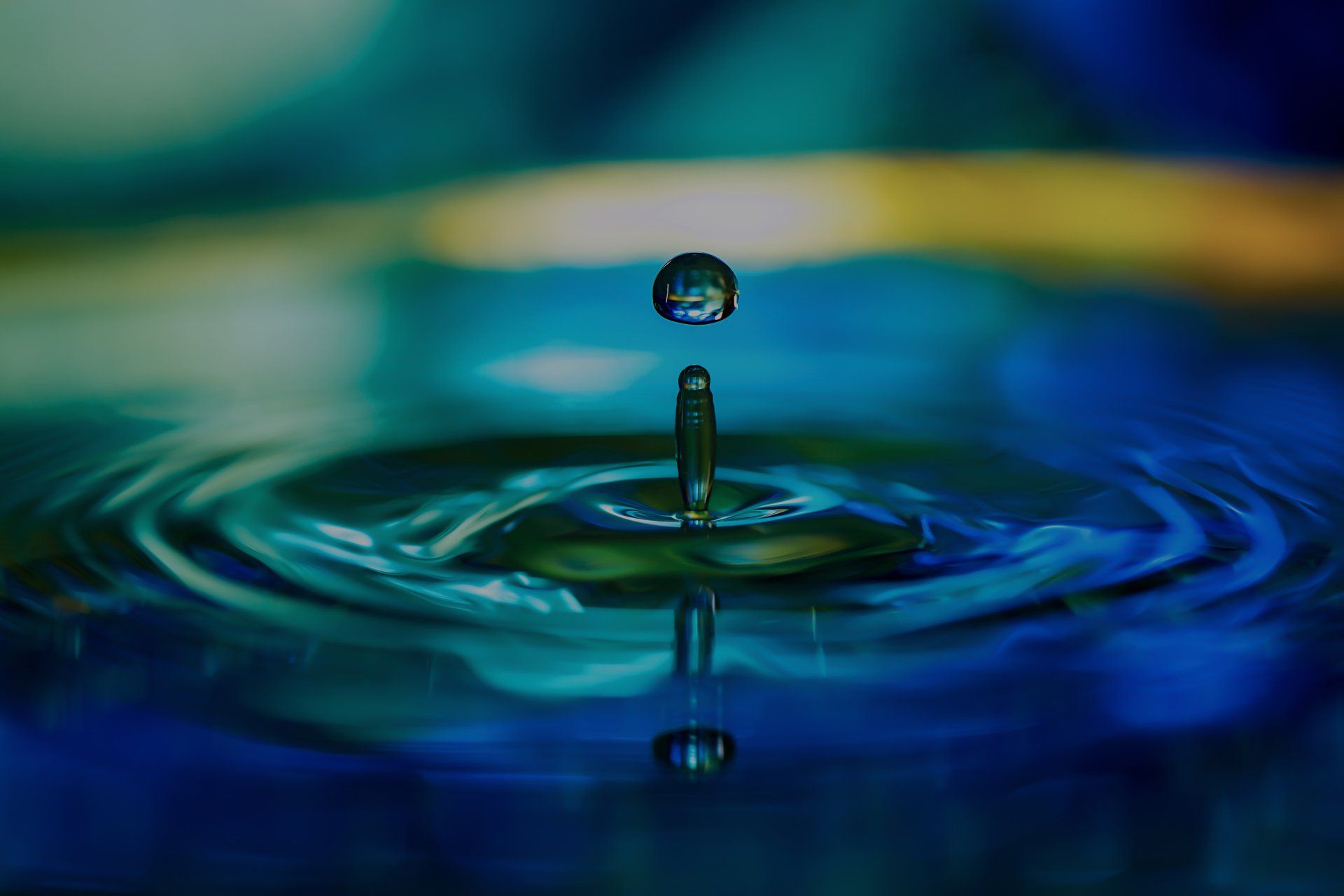A drop of water is falling into a pool of water.