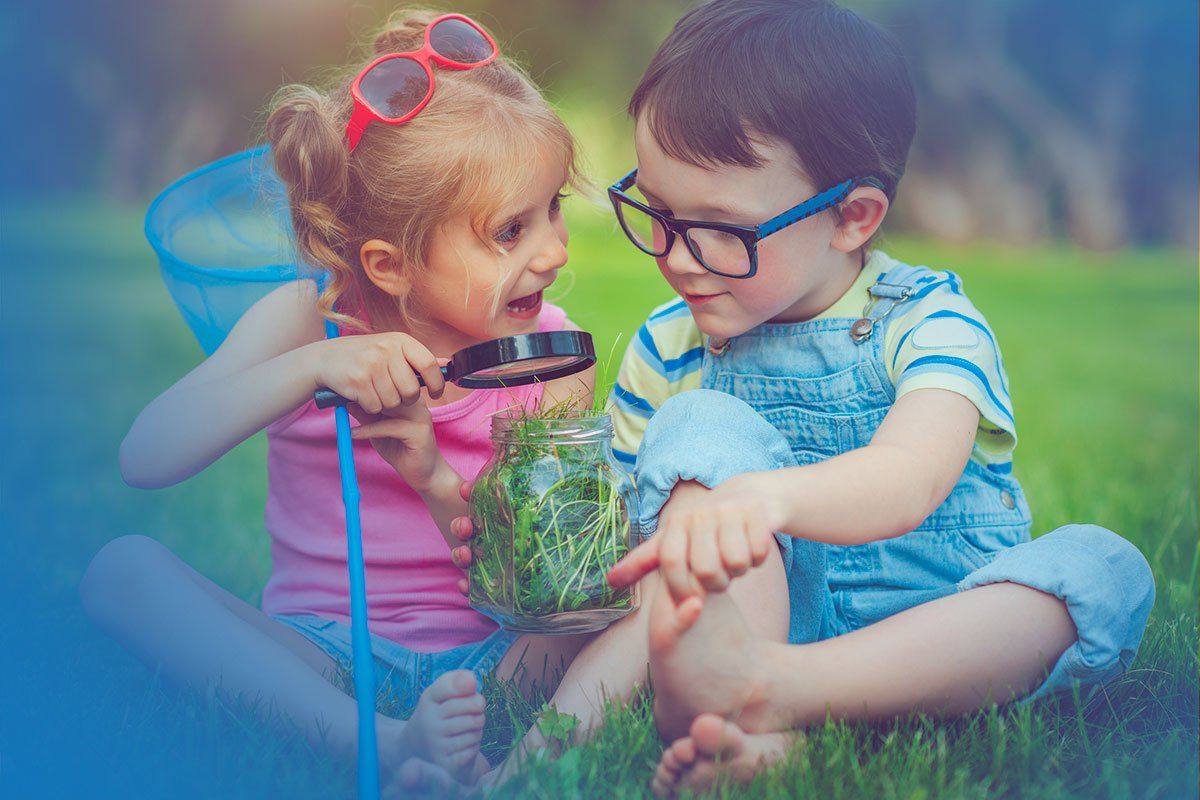 Girl and Boy sitting in Grass