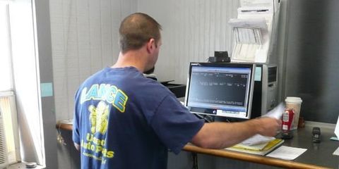 A Man Using the Computer — Lawrenceville, GA — Lance Used Auto Parts A Man Using the Computer — Lawrenceville, GA — Lance Used Auto Parts