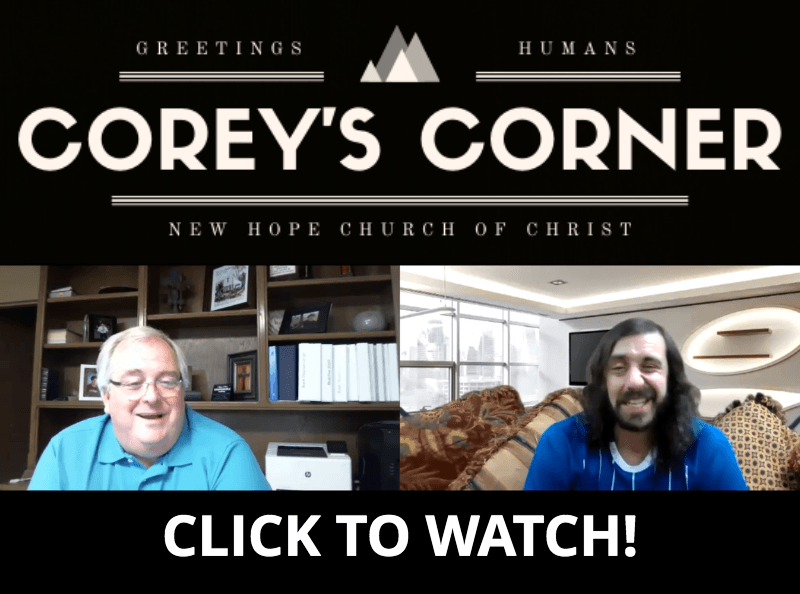 Two men are sitting in front of a sign that says corey 's corner