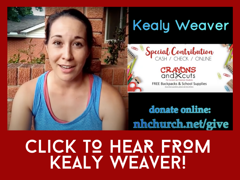 A woman in a blue tank top is standing in front of a sign that says special contribution cash check online crayons and xcuts
