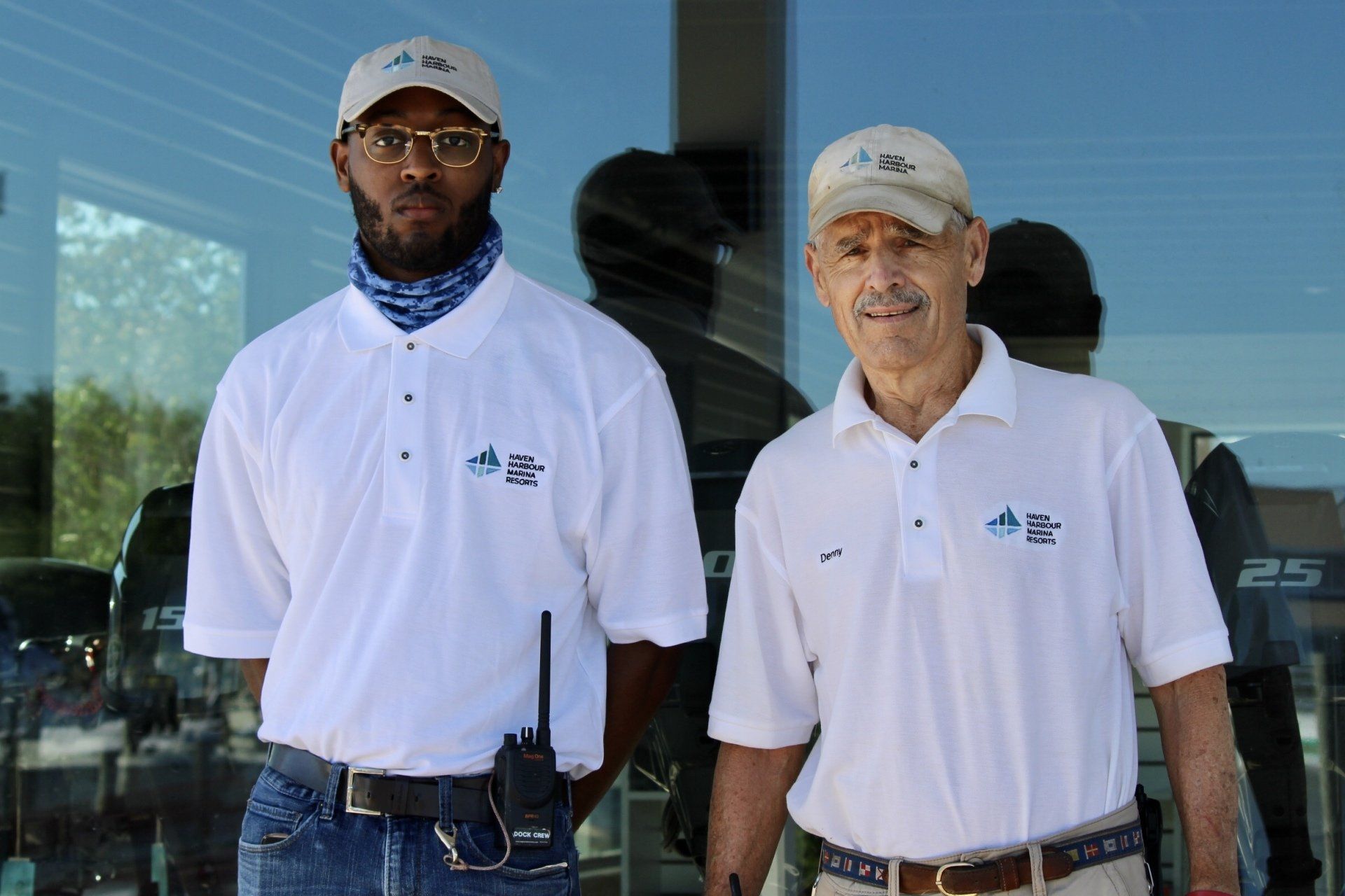 Two employees pictured outside in front of a window