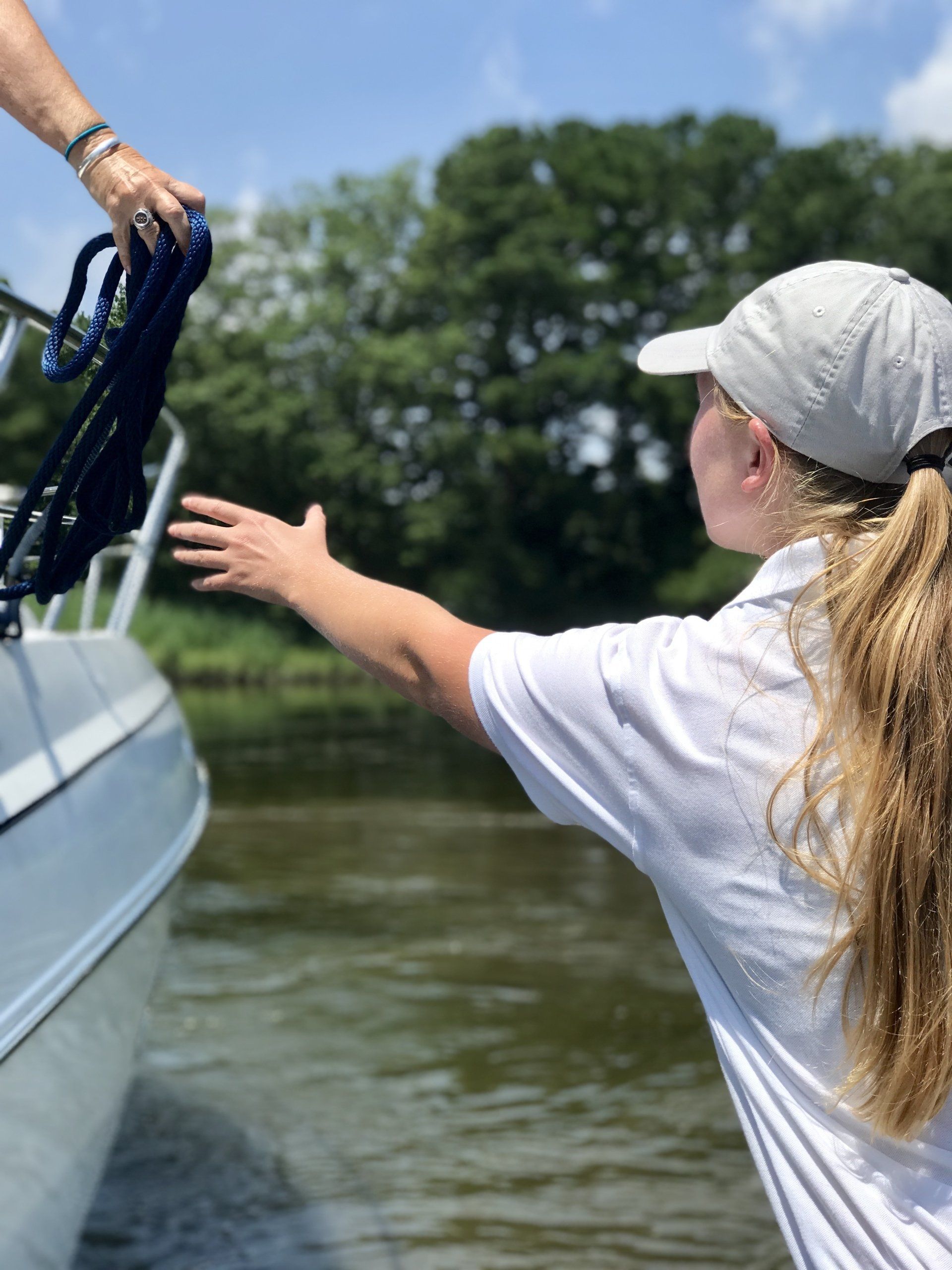 Employee reaching for rope before docking boat