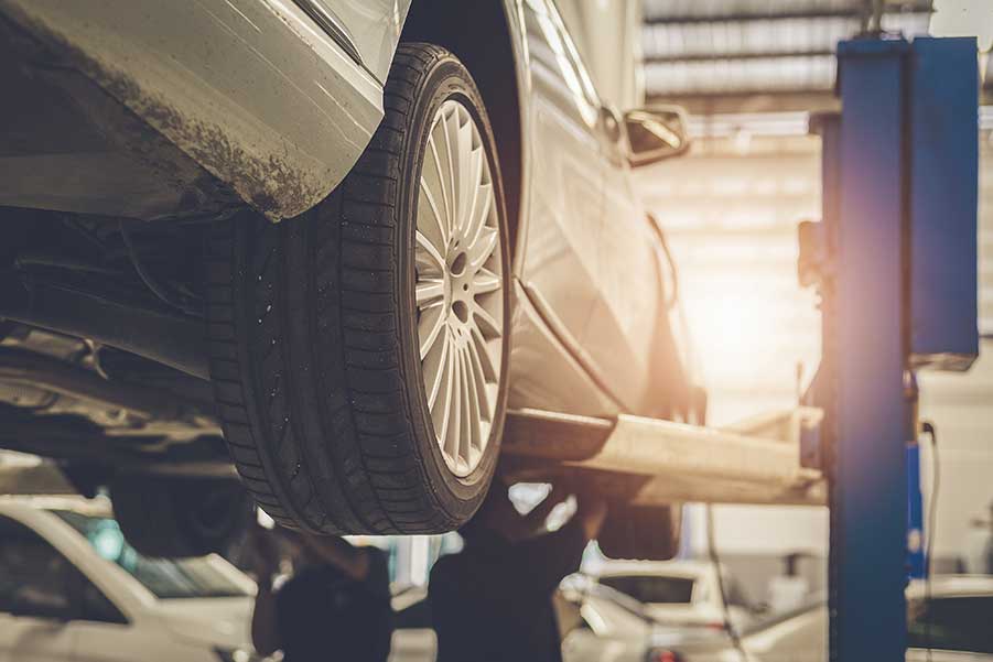 A car is being lifted on a lift in a garage.