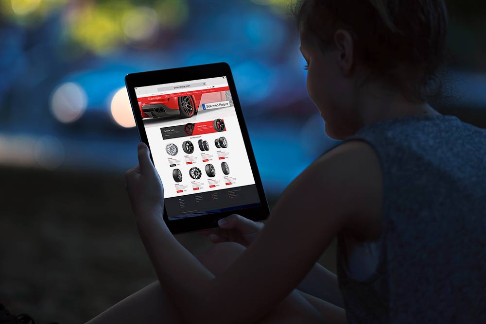 A woman is sitting on the ground using a tablet computer for tires