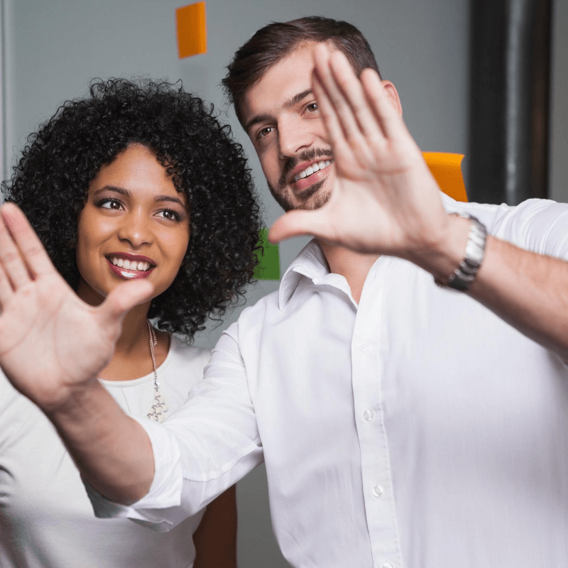 Professional hispanic male visionary explaining a big idea to a female colleague.