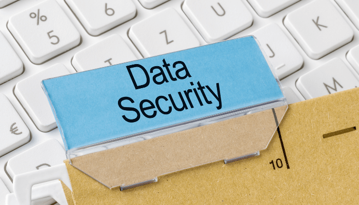 Closeup picture of keyboard with a file folder labeled “data security.”