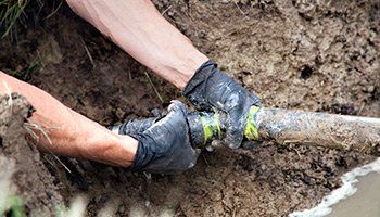 Man Fixing Pipe — Pembroke, GA — Huggins Waste Services