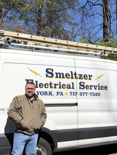 Worker Fixing Ceiling Light — Seven Valleys, PA — Smeltzer Electrical Service, LLC. Worker Fixing Ceiling Light — Seven Valleys, PA — Smeltzer Electrical Service, LLC.