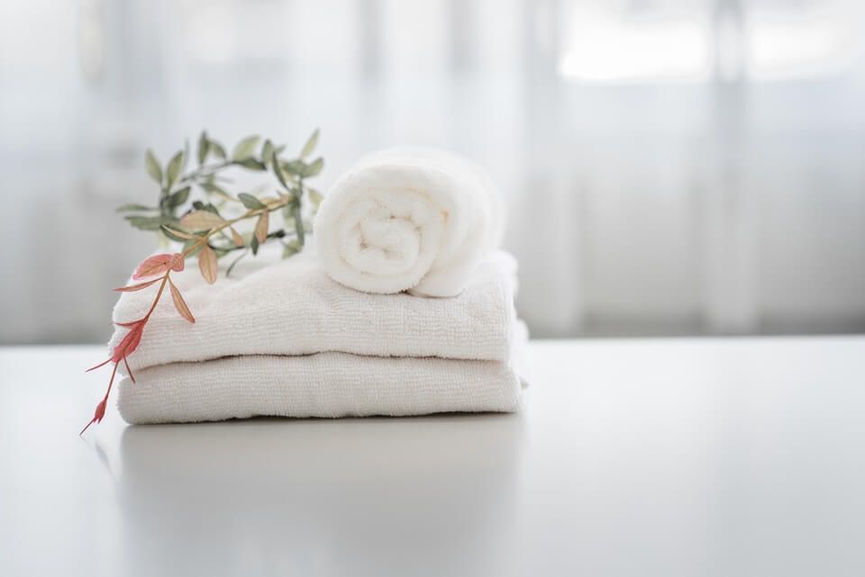 white folded towels in the bathroom