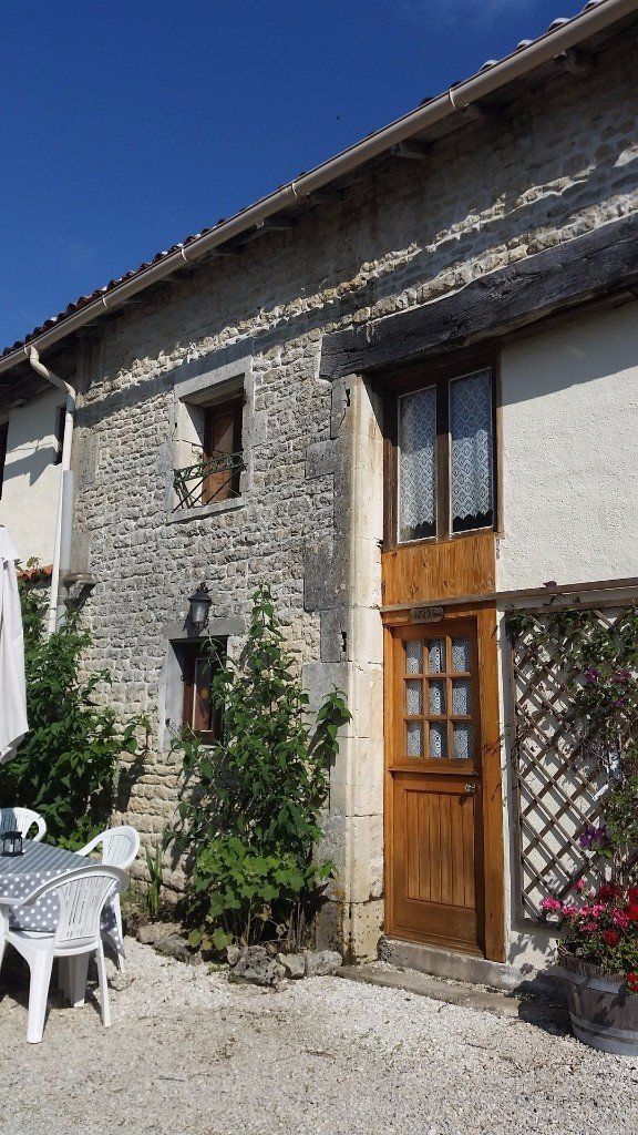 stone cottage with wooden door and windows