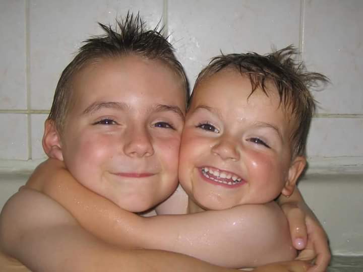 two boys hugging each other