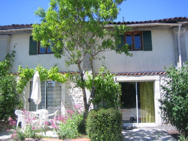 Holiday cottage with a Peach tree in front