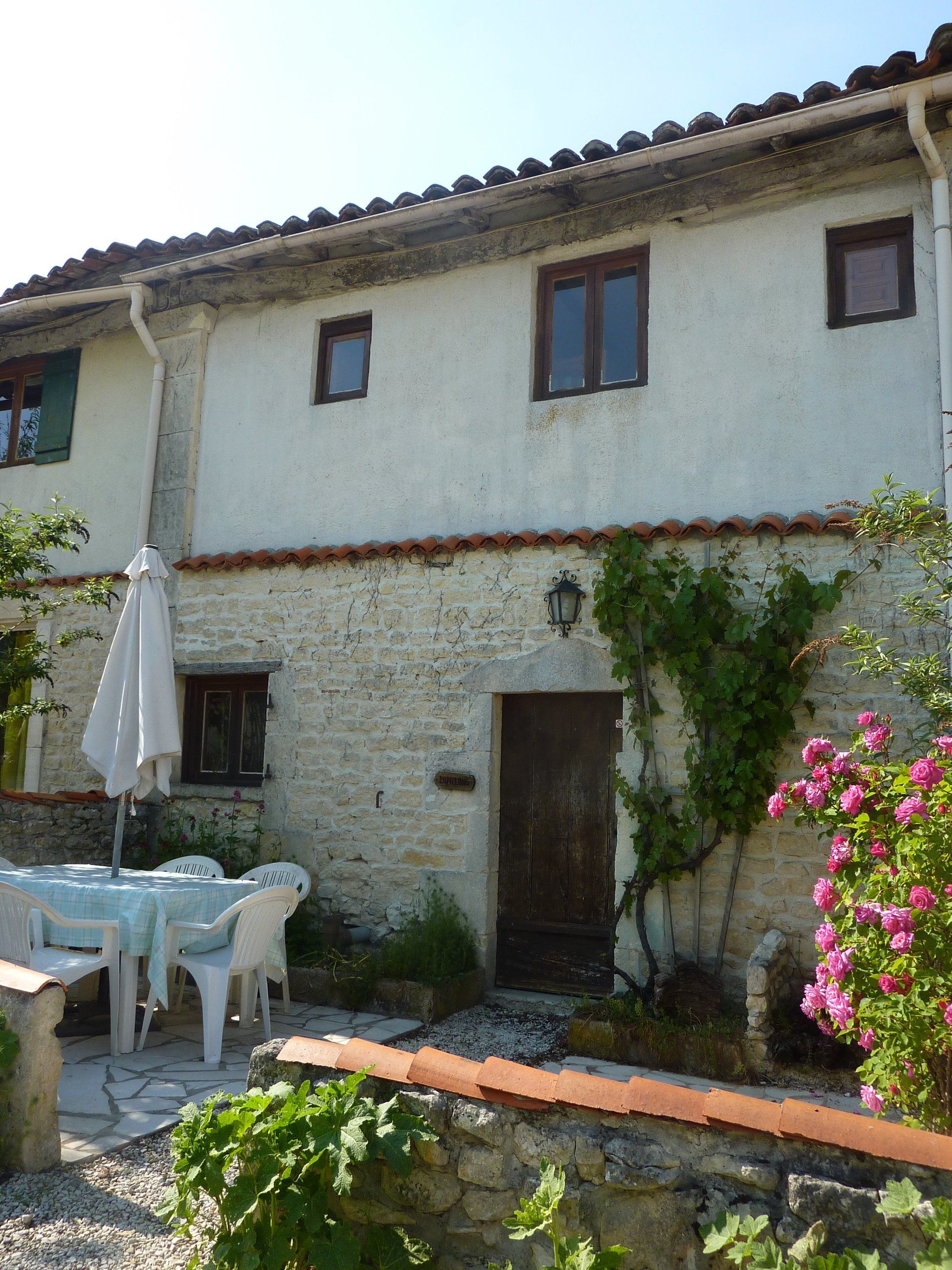 French Holiday cottage with wooden door and table and chairs outside