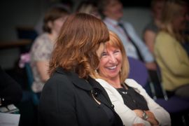 Two  smilingwomen sitting and looking at each other