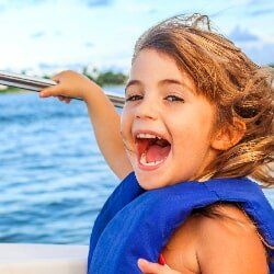 Happy Girl Riding a Boat — Boat Club in Orange Beach, AL Happy Girl Riding a Boat — Boat Club in Orange Beach, AL