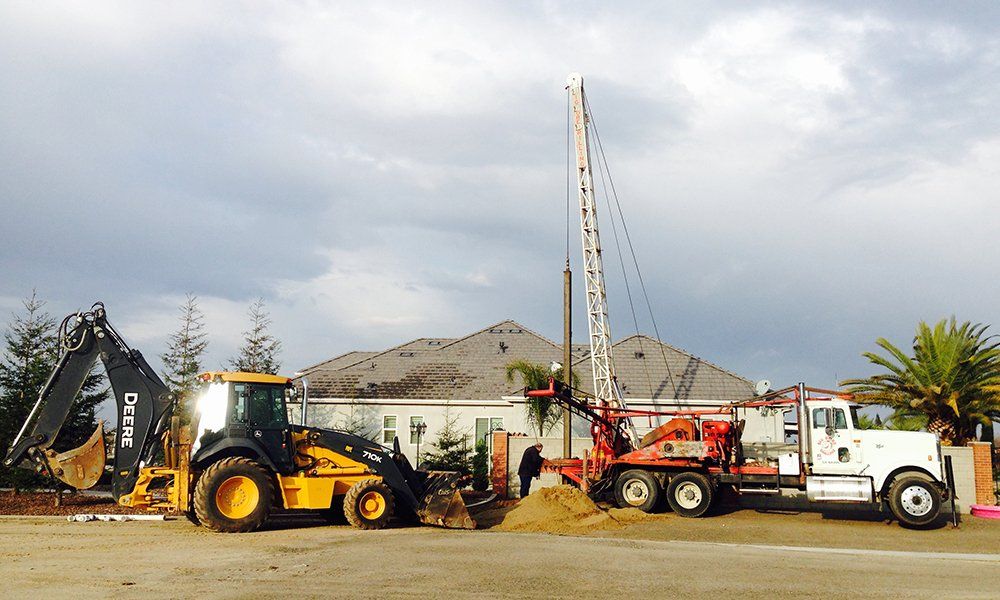 Construction Site with Heavy Duty Machinery — Fresno, CA — Big Bore Drilling Certified Septic & Hydroflushing Construction Site with Heavy Duty Machinery — Fresno, CA — Big Bore Drilling Certified Septic & Hydroflushing