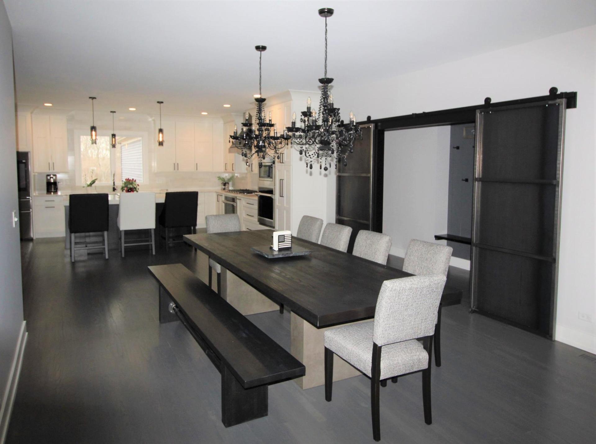A dining room with a long table and benches