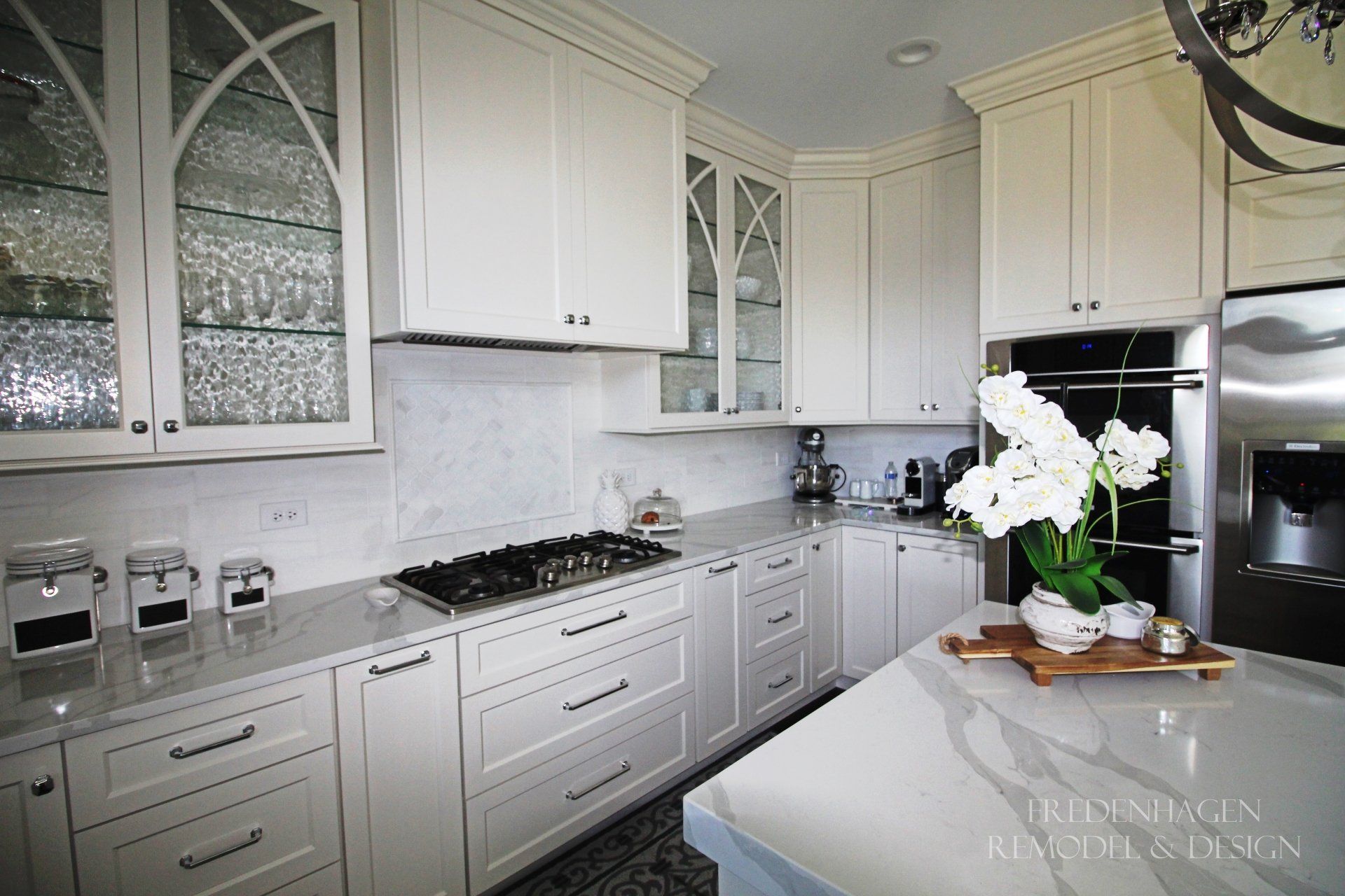 A kitchen with white cabinets and stainless steel appliances