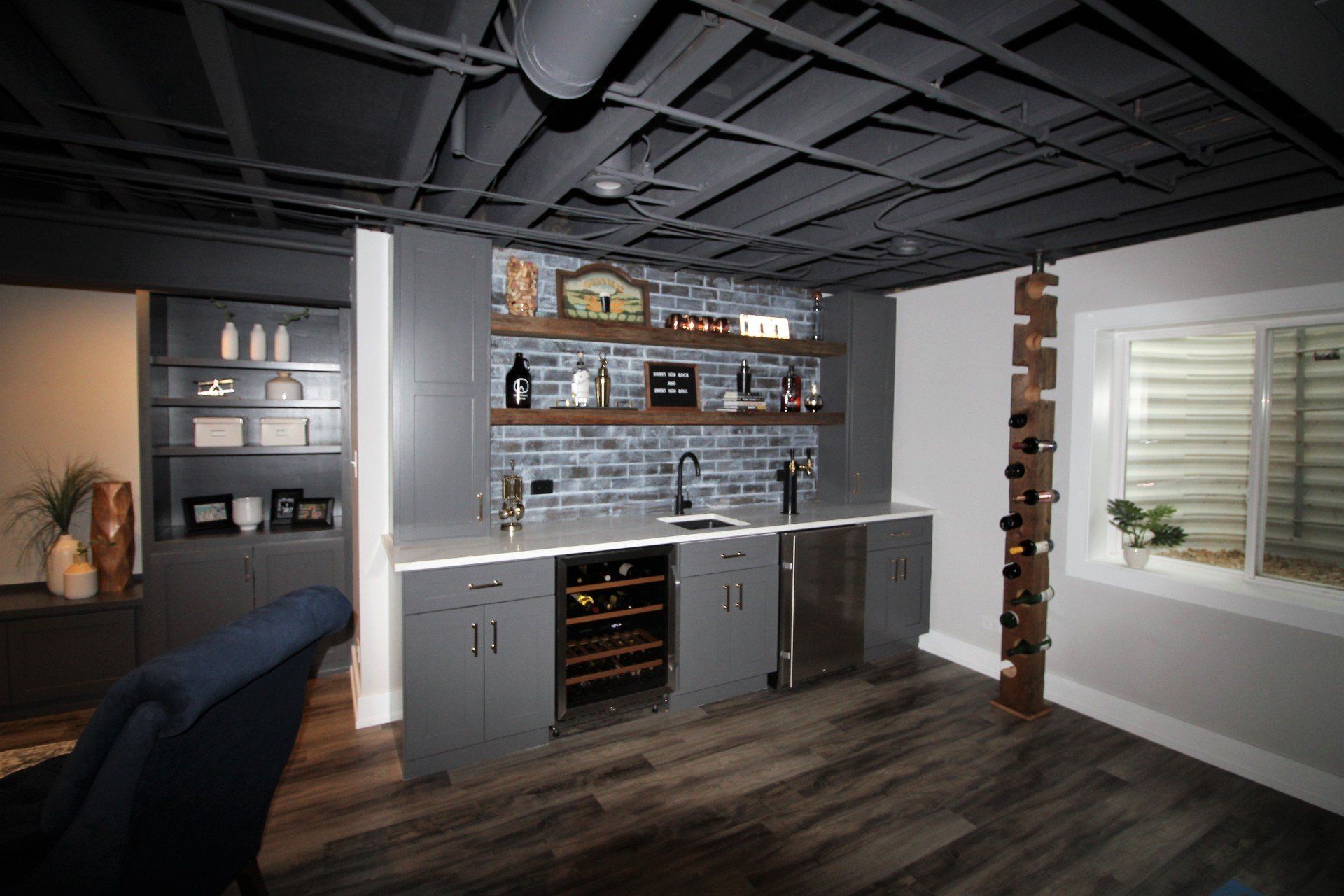 A basement with a bar and a wine rack