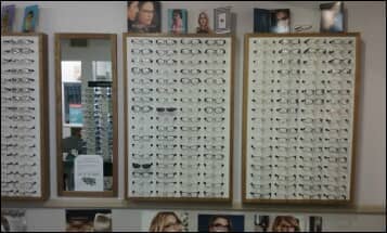 Eyeglass rack with mirror — Vision Exams In Colorado, CO Eyeglass rack with mirror — Vision Exams In Colorado, CO