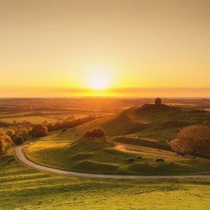 The sun rising over acres of land