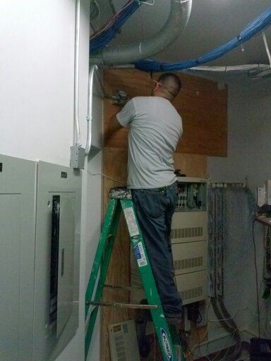 Circuit rewiring and repairs — Man fixing solar panel in Chino Hills, CA Circuit rewiring and repairs — Man fixing solar panel in Chino Hills, CA