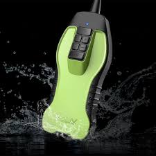 Green and black handheld ultrasound scanner against a dark background with water splashes.