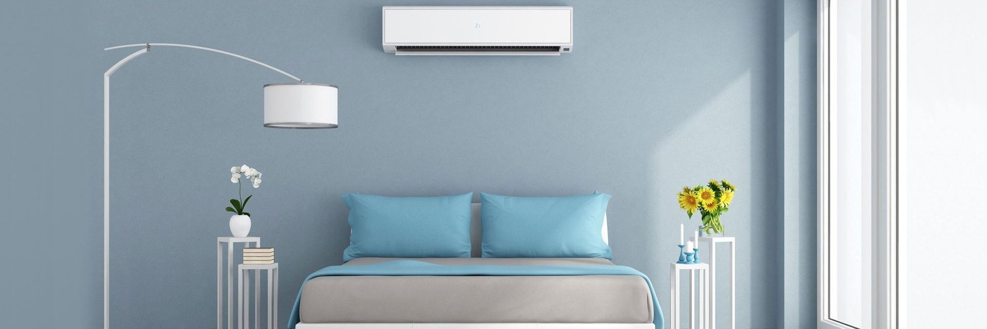 A bedroom with blue walls, a bed, bedside tables with plants, and an air conditioner.