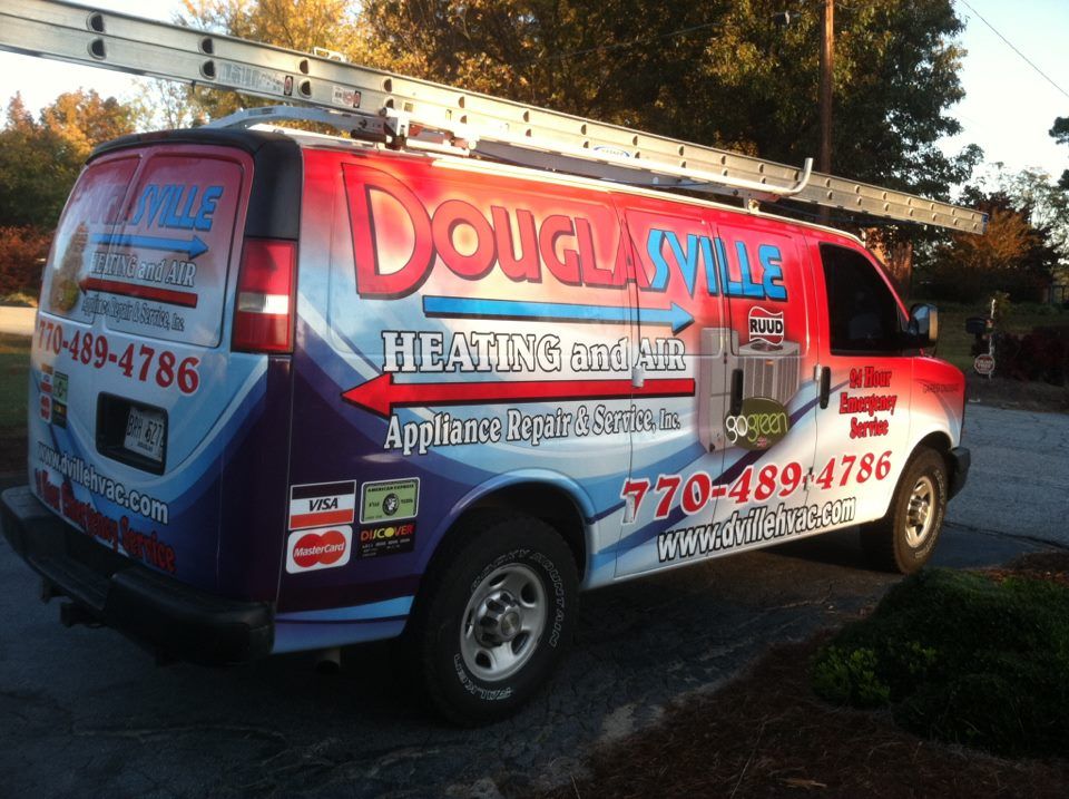 A Man Repairing the Air Conditioner — Douglasville, GA — Douglasville Heating and Air and Appliance