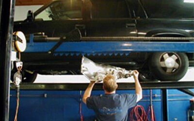 Transmission Services — Man and a Lifted Car  in Burlingame, CA